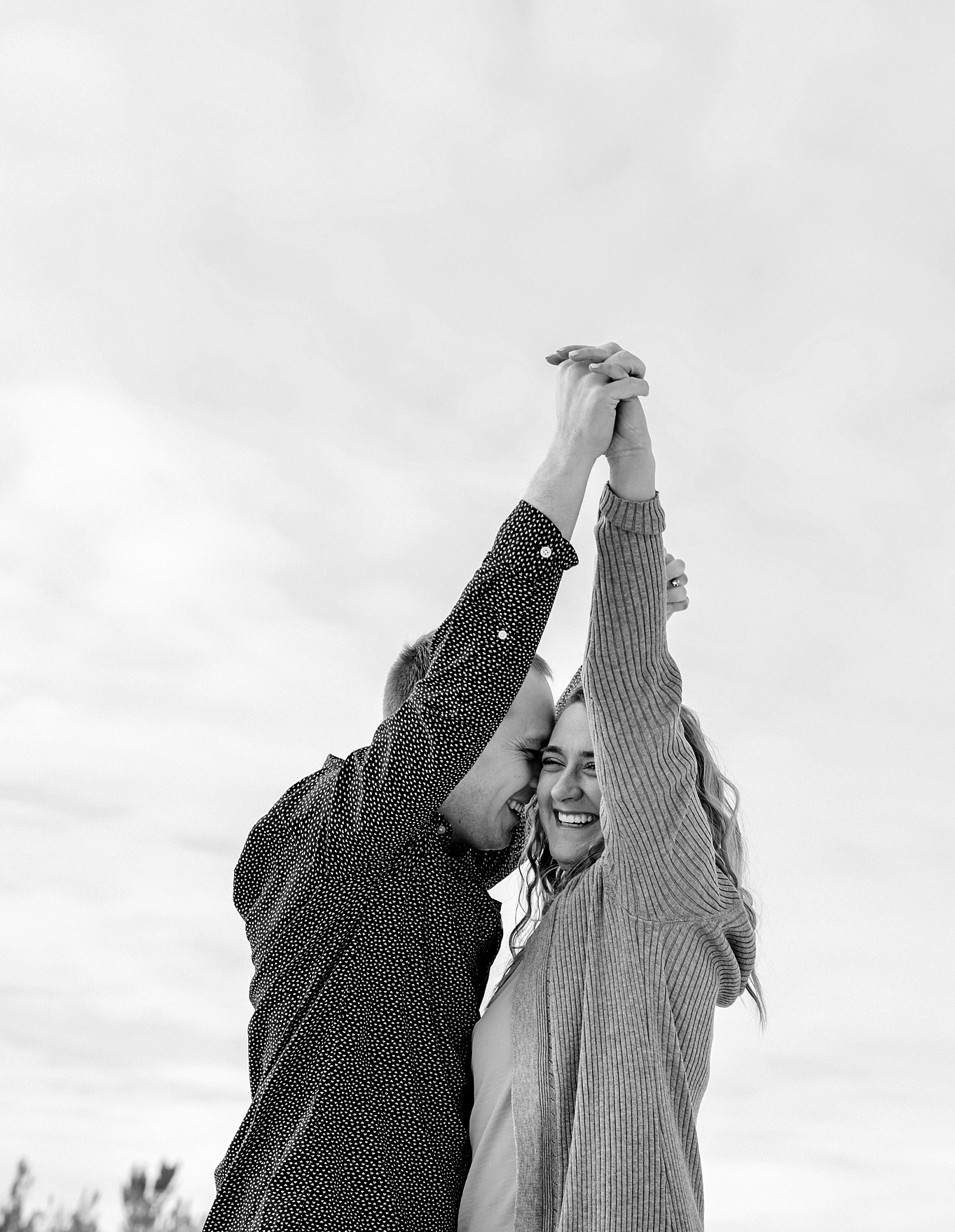 rexburg engagement photographer janelle and co engaged couple holding hands and kissing in the snow