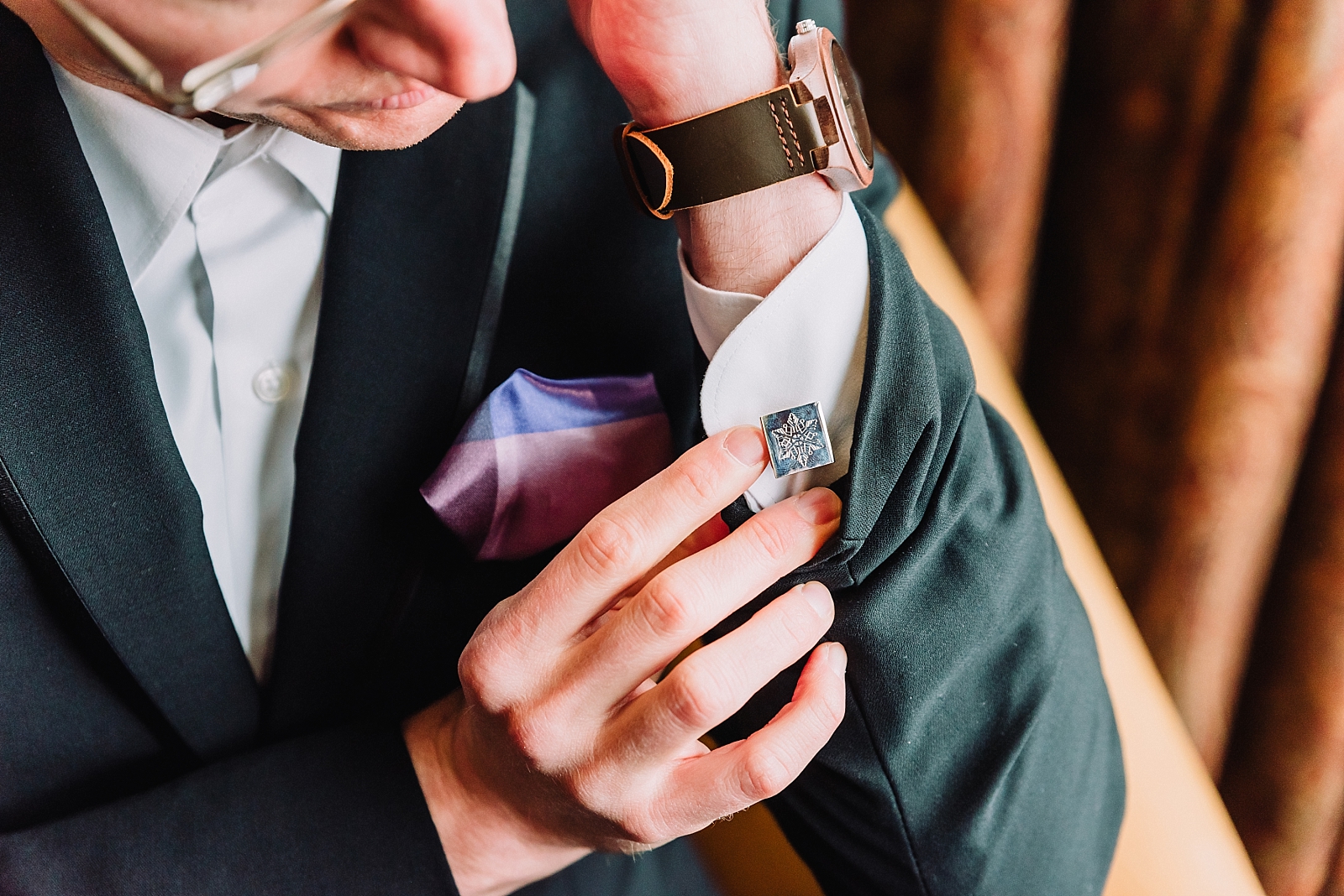 groom buttoning cufflinks