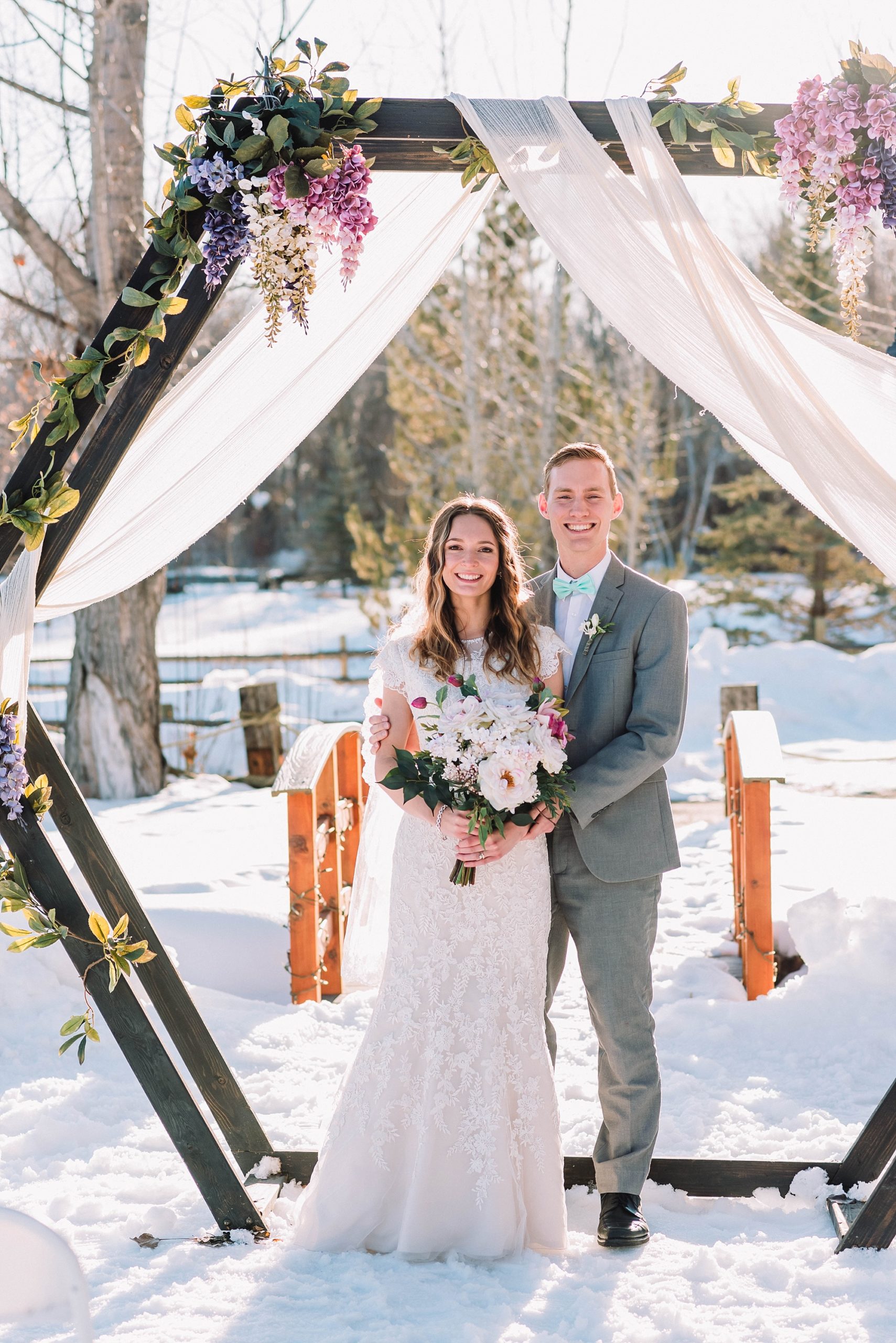 outdoor-wedding-ceremony-flower-arch-snow-winter-lavender