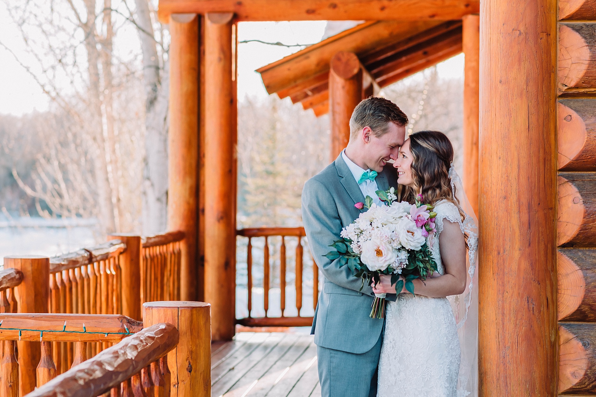 bride and groom at winter cabin wedding