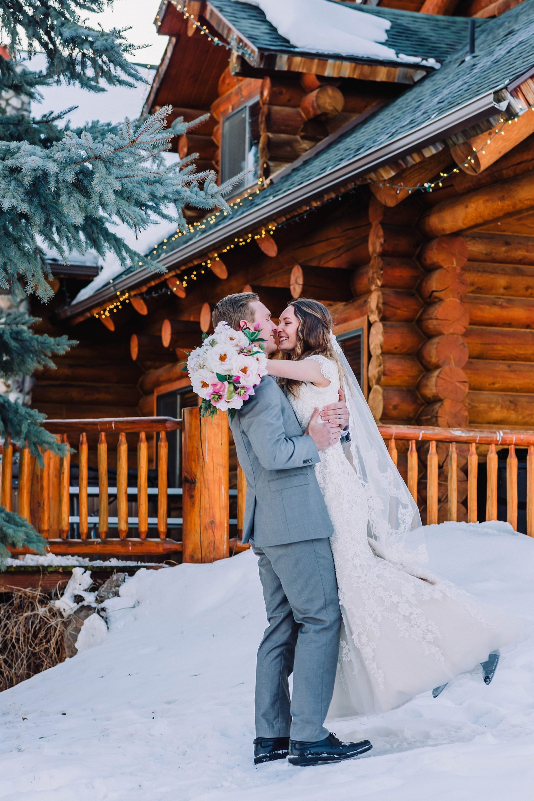 bride and groom in the snow at labelle lake rigby idaho wedding venue