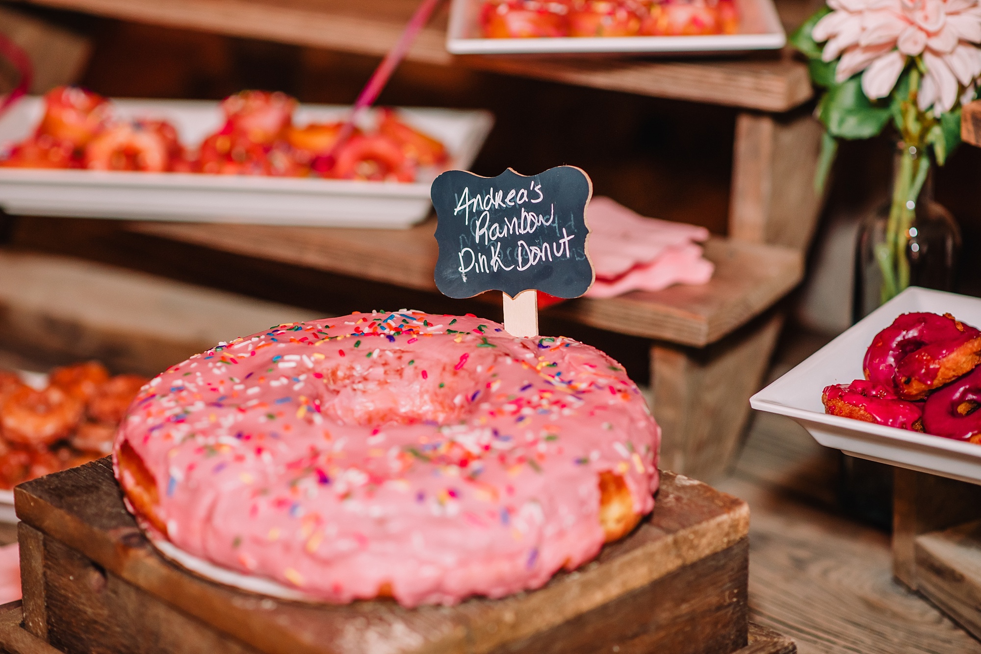 pink donut for worst wedding traditions to skip. Skip cake and eat doughnuts! 