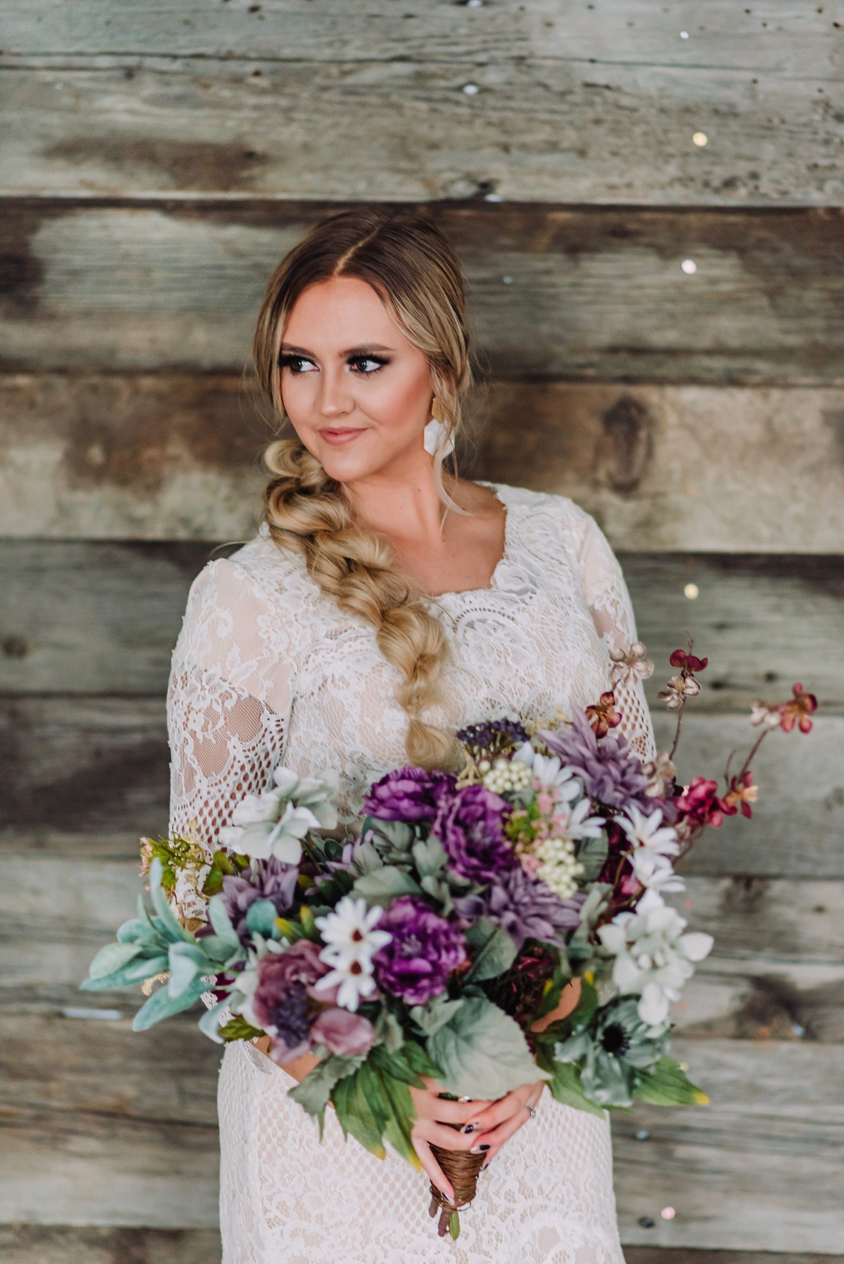 bride with wedding bouquet and flowers lesbian wedding flower inspiration purple and sage