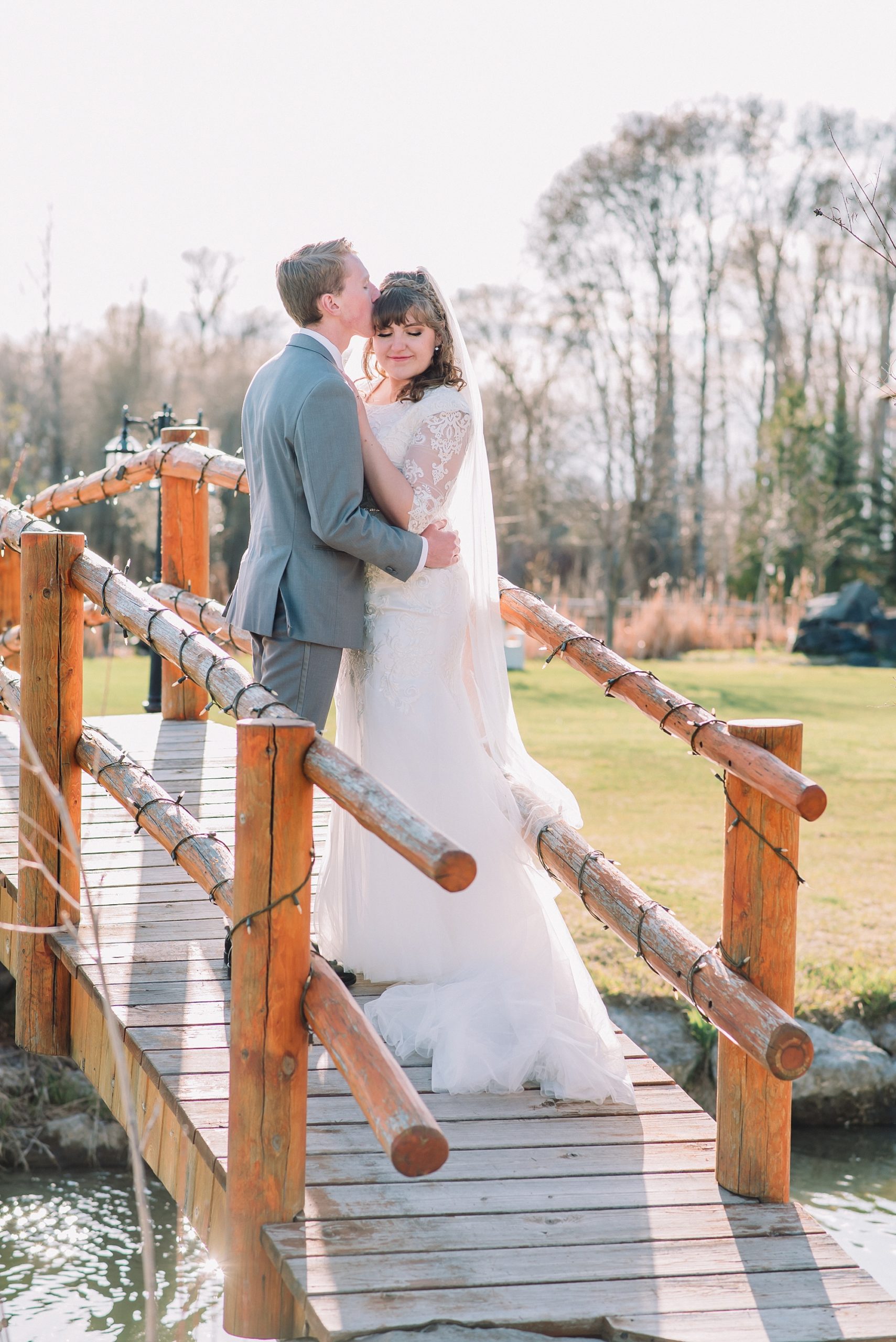 bride-and-groom-on-wooden-rustic-bridge-at-labelle-lake-idaho