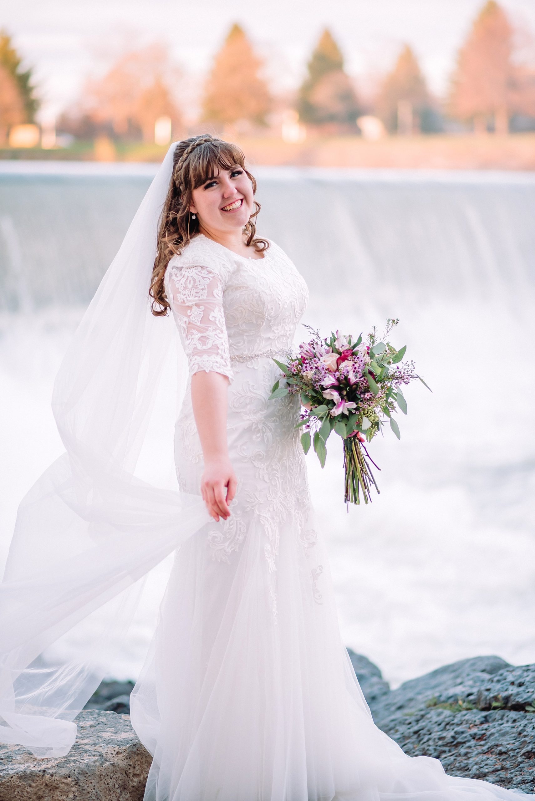 bride-with-bouquet-at-the-greenbelt-waterfall-idaho-falls-spring-bridals-wedding-photographer
