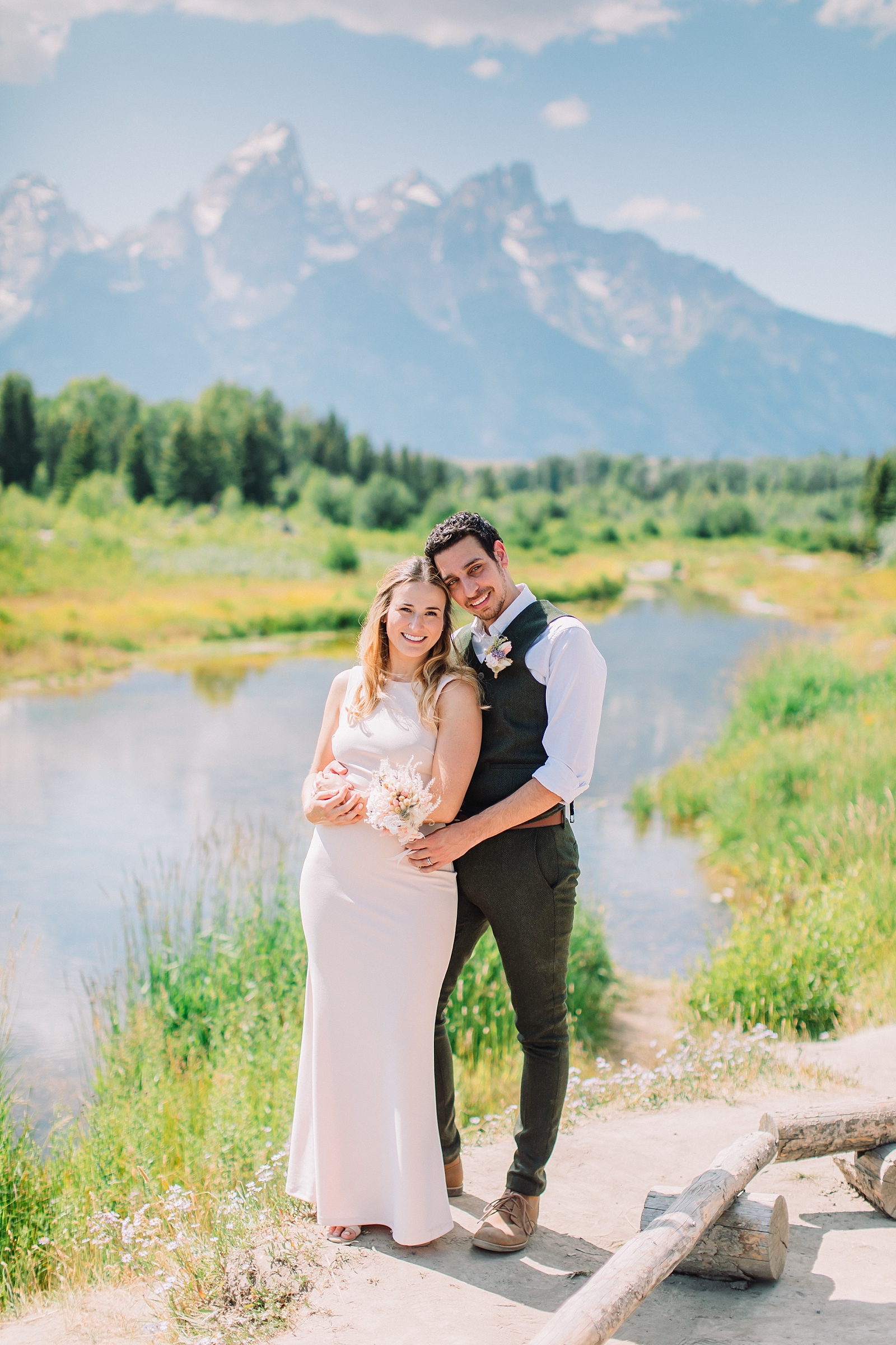 bride and groom with mountains tetons