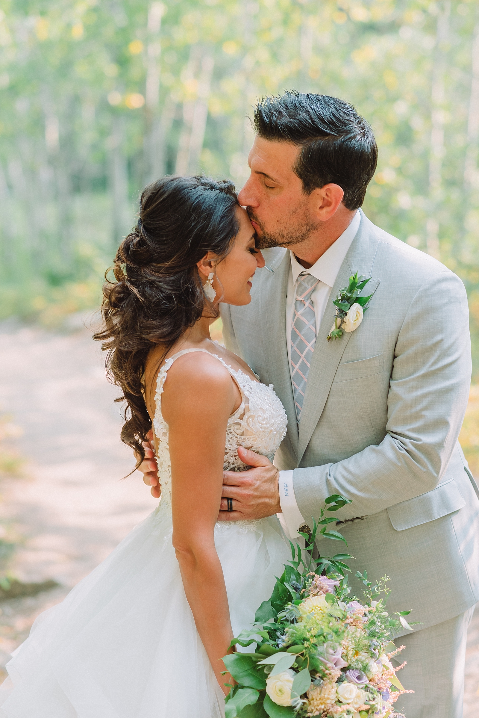 bride and groom kissing after elopement at taggard at jackson hole hiking lakes