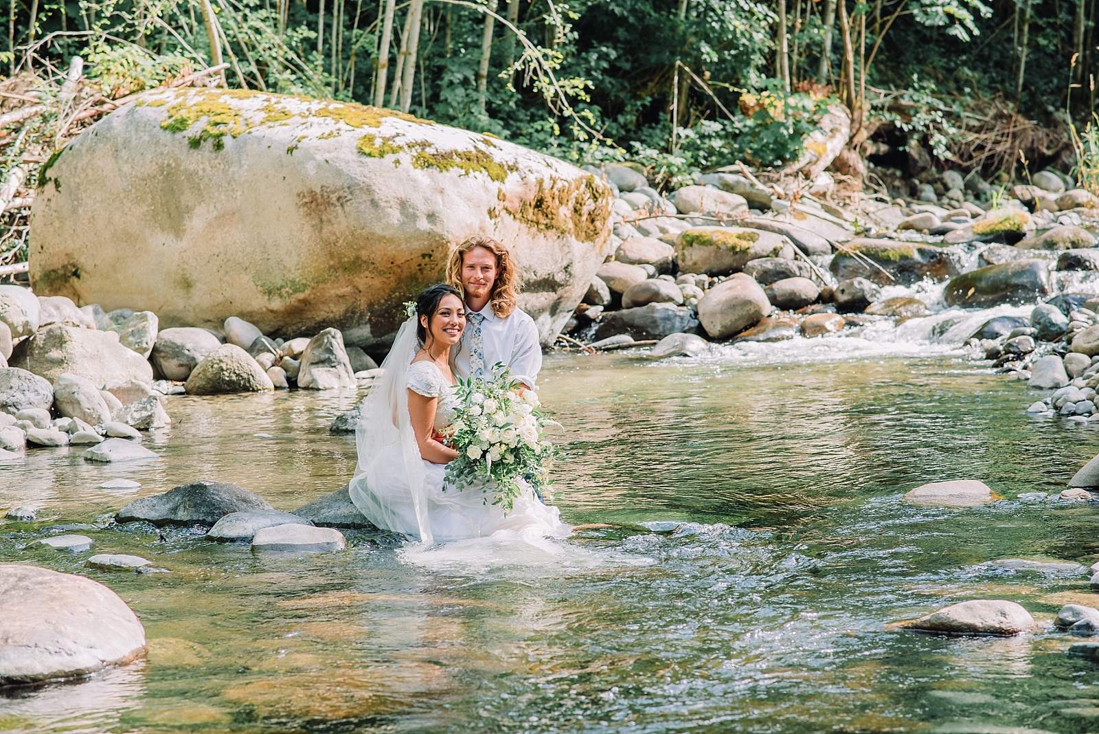 bride and groom in water river wedding clothes