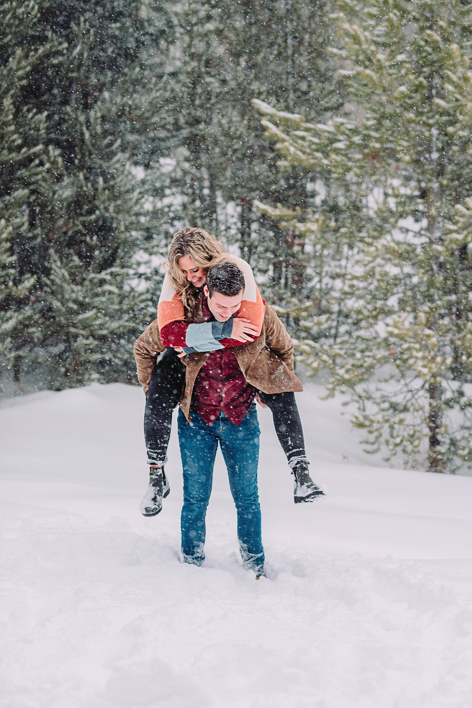 couple playing in the snow engagement session