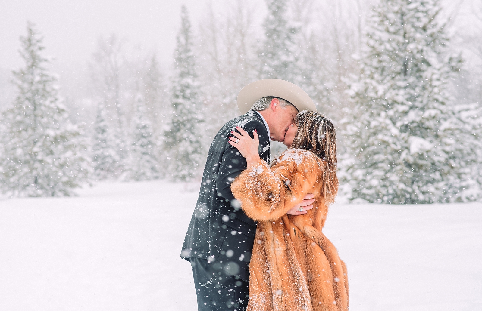 bride and groom kissing outdoors during winter elopement