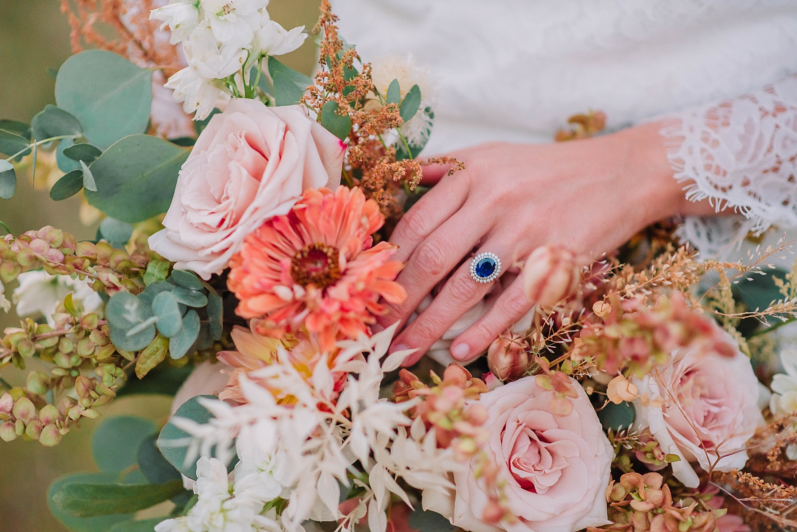 bride holding bouquet of pink florals with blue ring during wedding tradition of old, new, borrowed, and blue