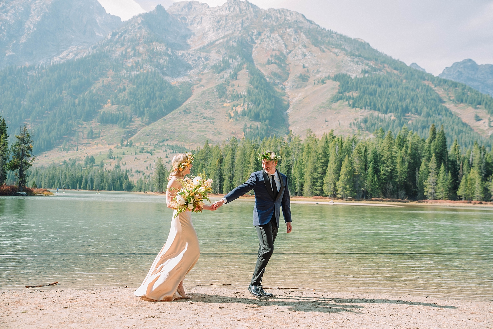 bride and groom holding hands at Jackson Hole Hiking lakes