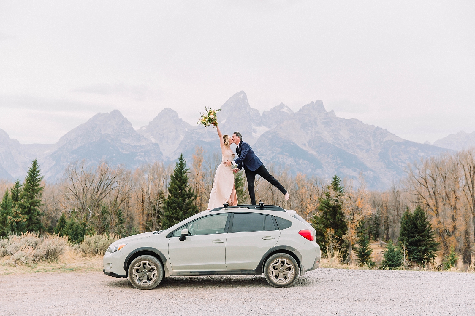 couple standing on car after grand teton national park spring wedding elopement