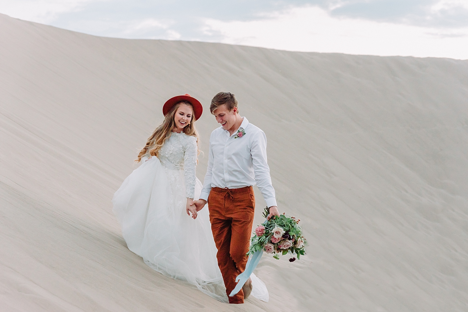 Couple walking on beach during beach inspired elopement