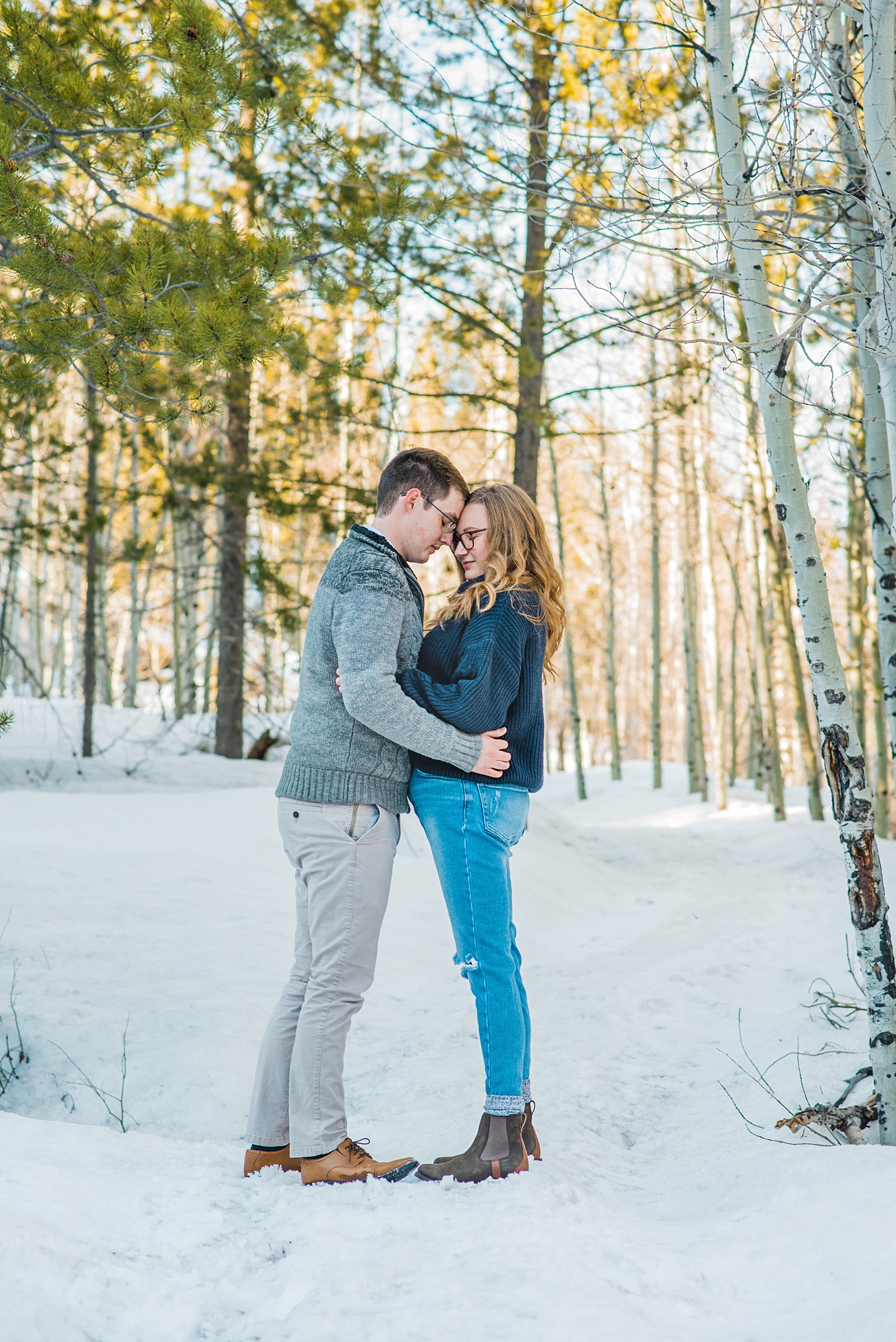 man and woman hugging in snowy jackson hole