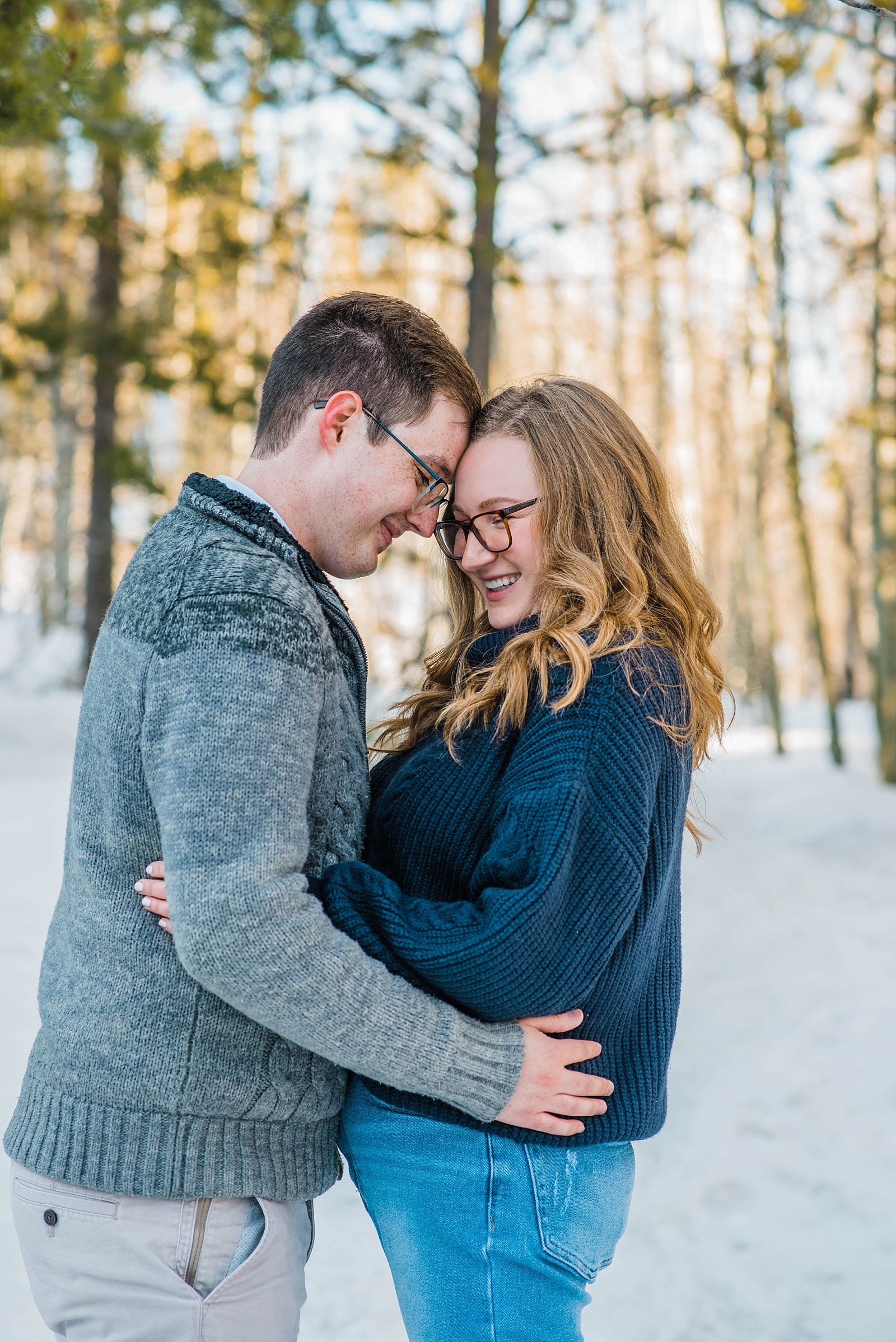 couple hugging in snowy jackson hole during outdoor couples portraits