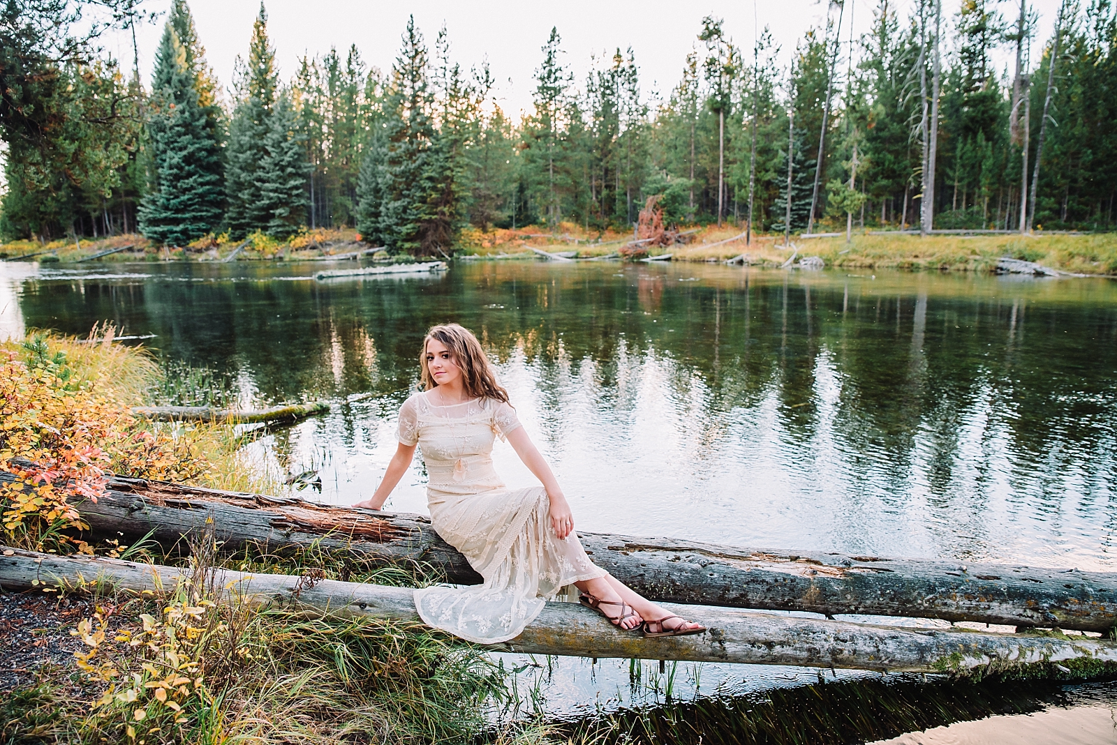 woman sitting on log at island park during outdoor elopement
