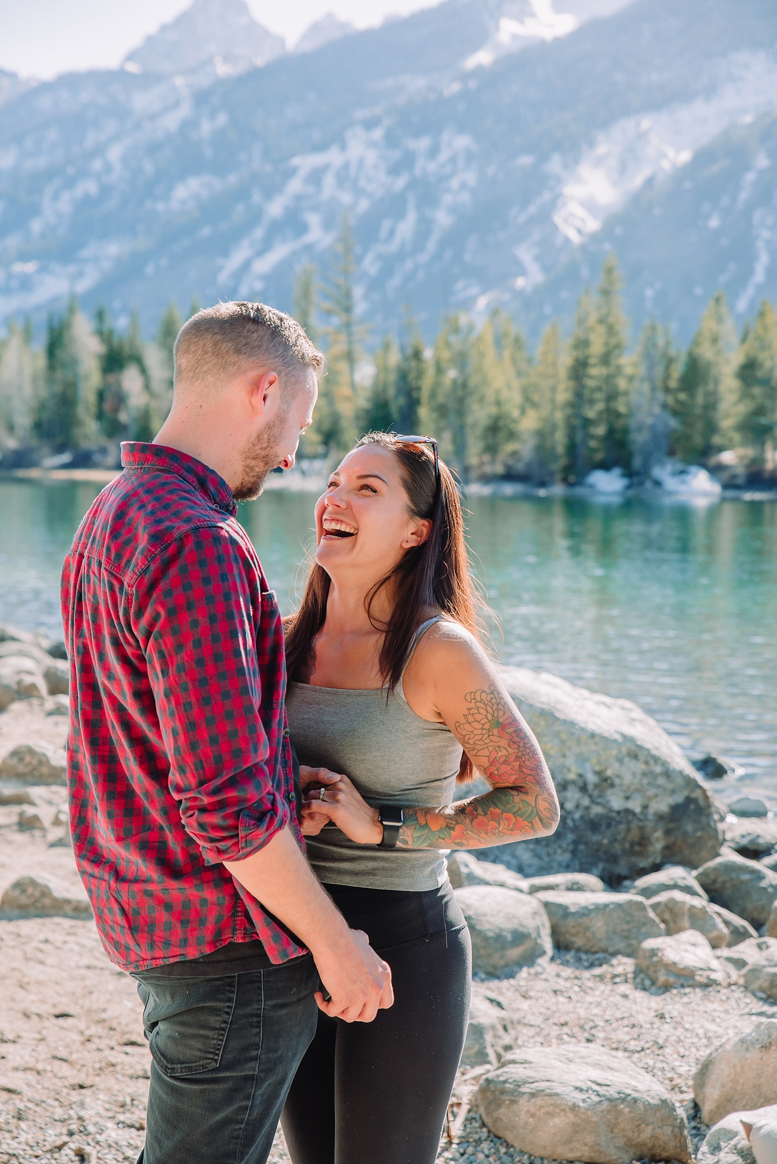 couple laughs together celebrating proposal