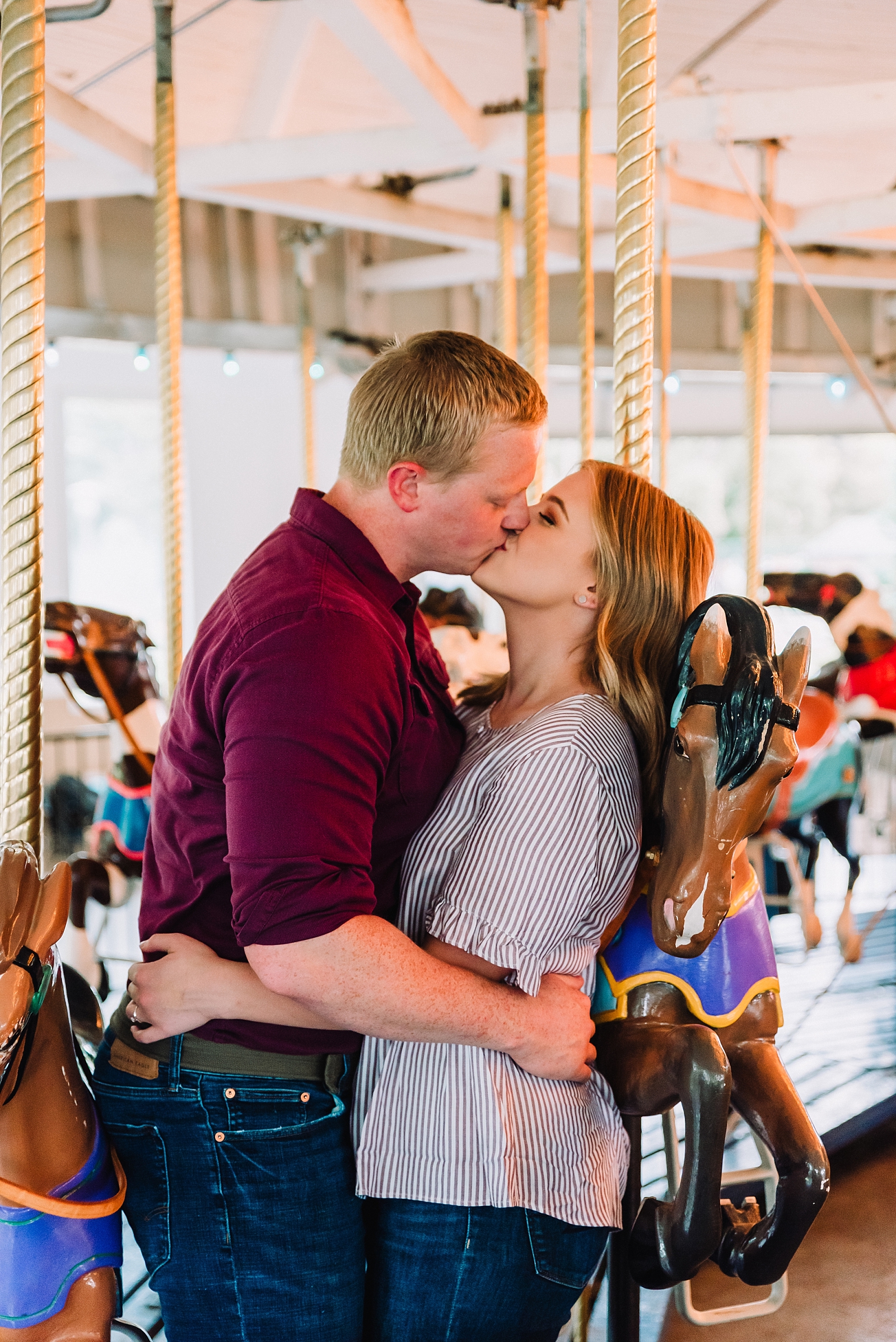 young couple kissing on carousel