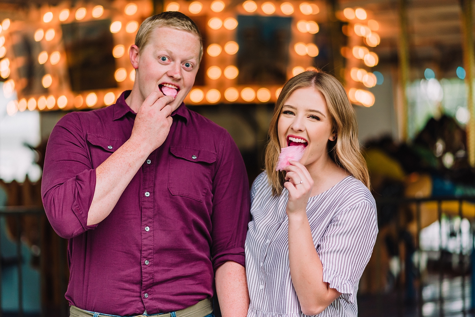 couple eating cotton candy together and making funny faces