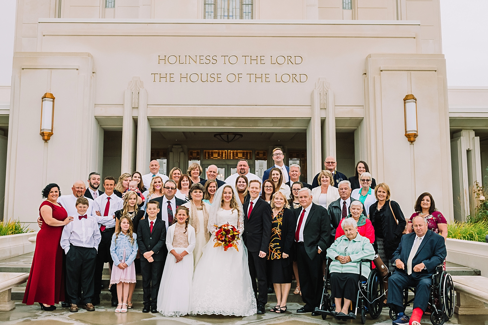 Family shot of everyone at wedding in Rexburg in front of temple
