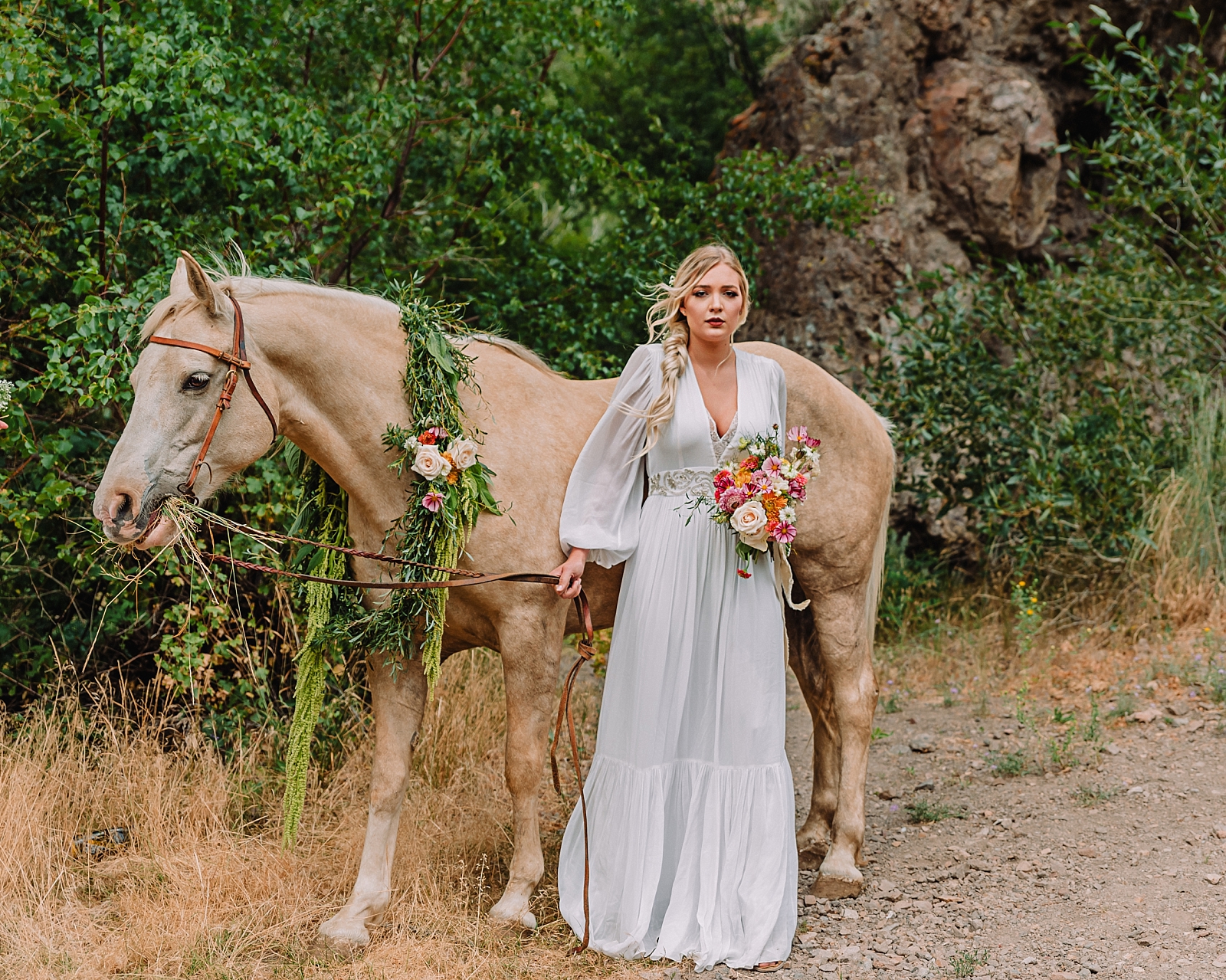 bride wearing long sleeve gown with boho chic style and a horse in Kelly Canyon