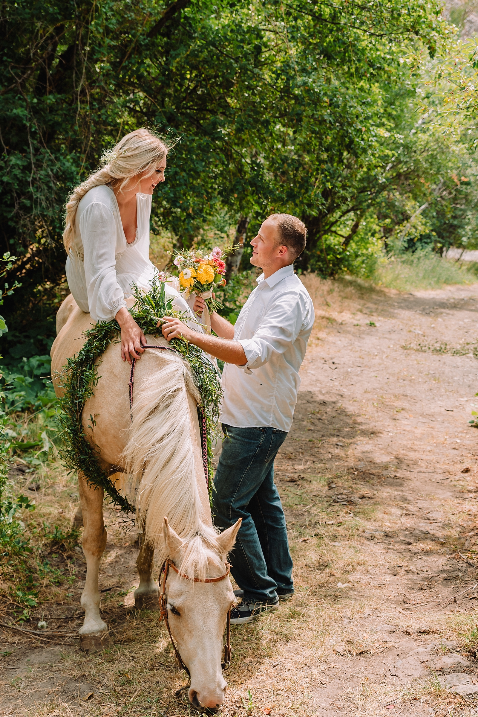 man and woman eloping in kelly canyon on a horse