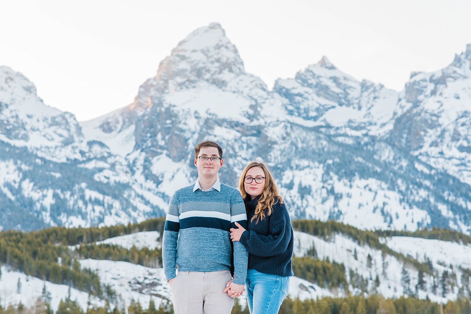 newly engaged couple holding hands in grand teton national park