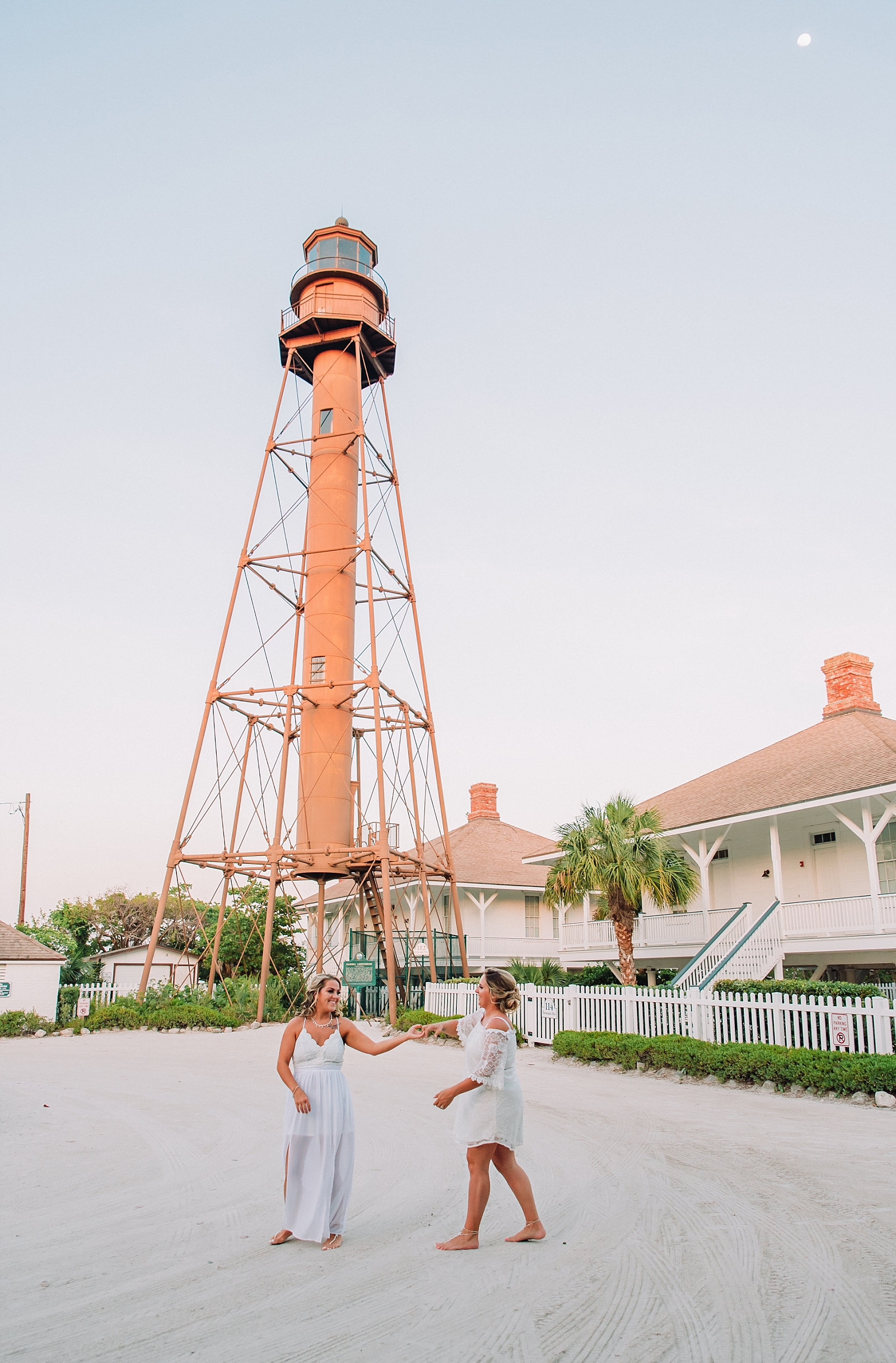 same-sex couple dances in front of sanibel island lighthouse