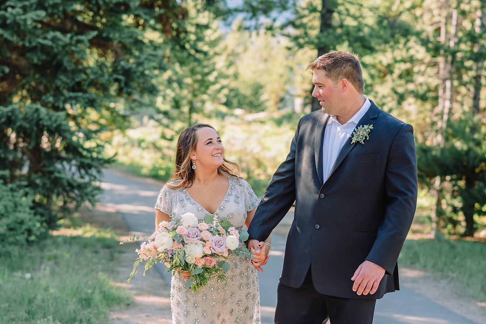 bride and groom walk in grand teton national park
