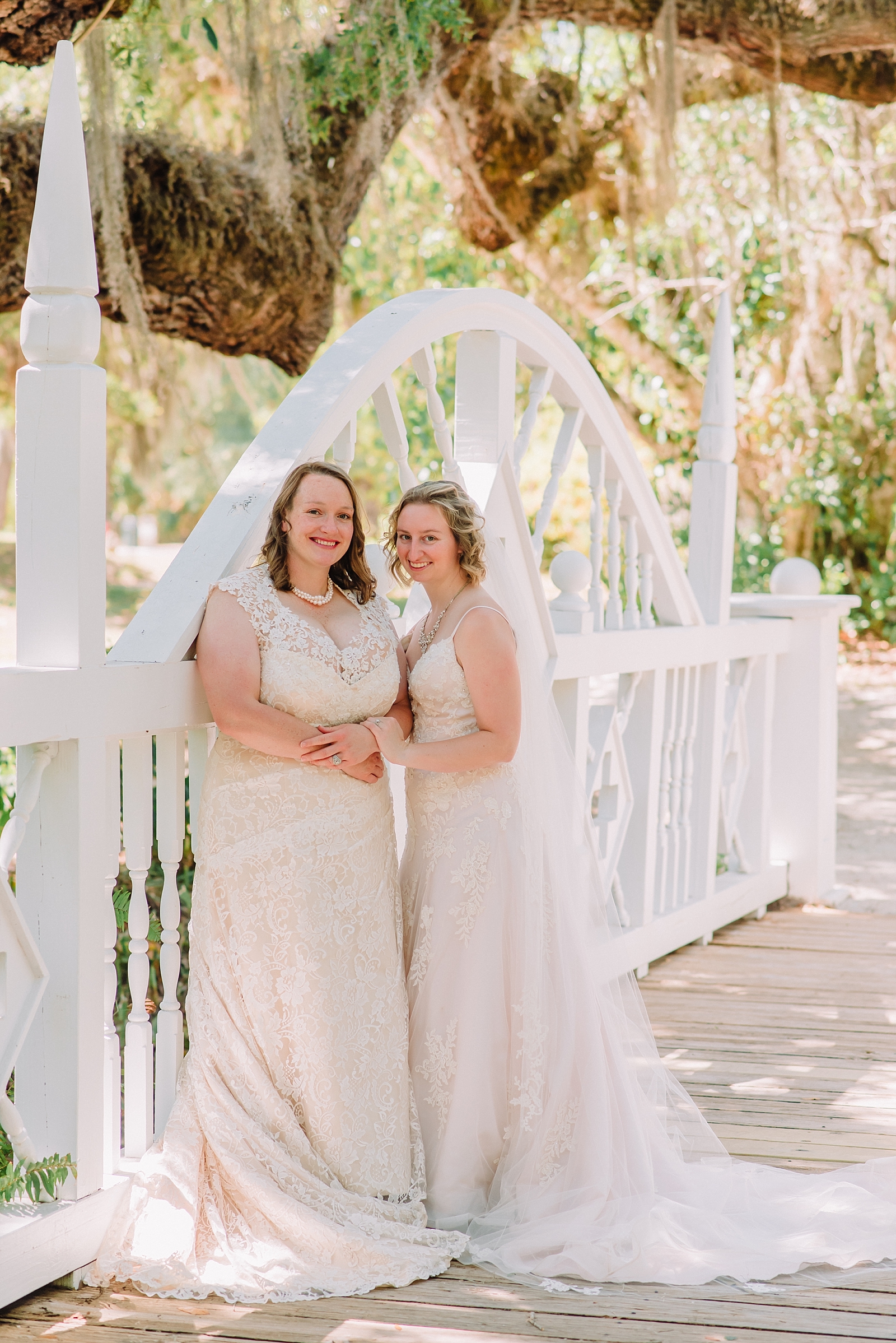 lesbian couple in wedding gowns at koreshan state park