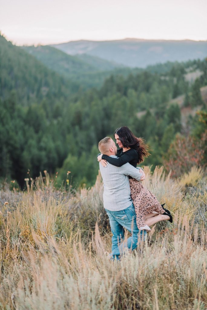 couple dances in the mountain brush, romantic engagements