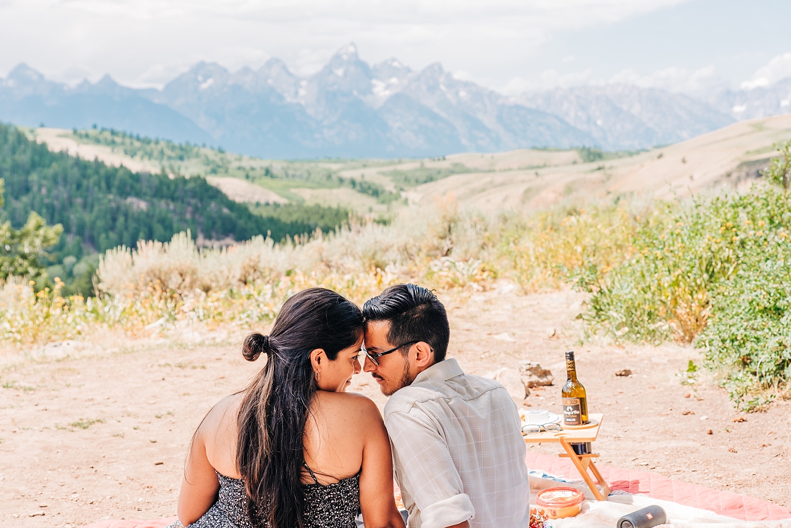 couple celebrating surprise proposal with charcuterie board from Jackson Hole Charcuterie