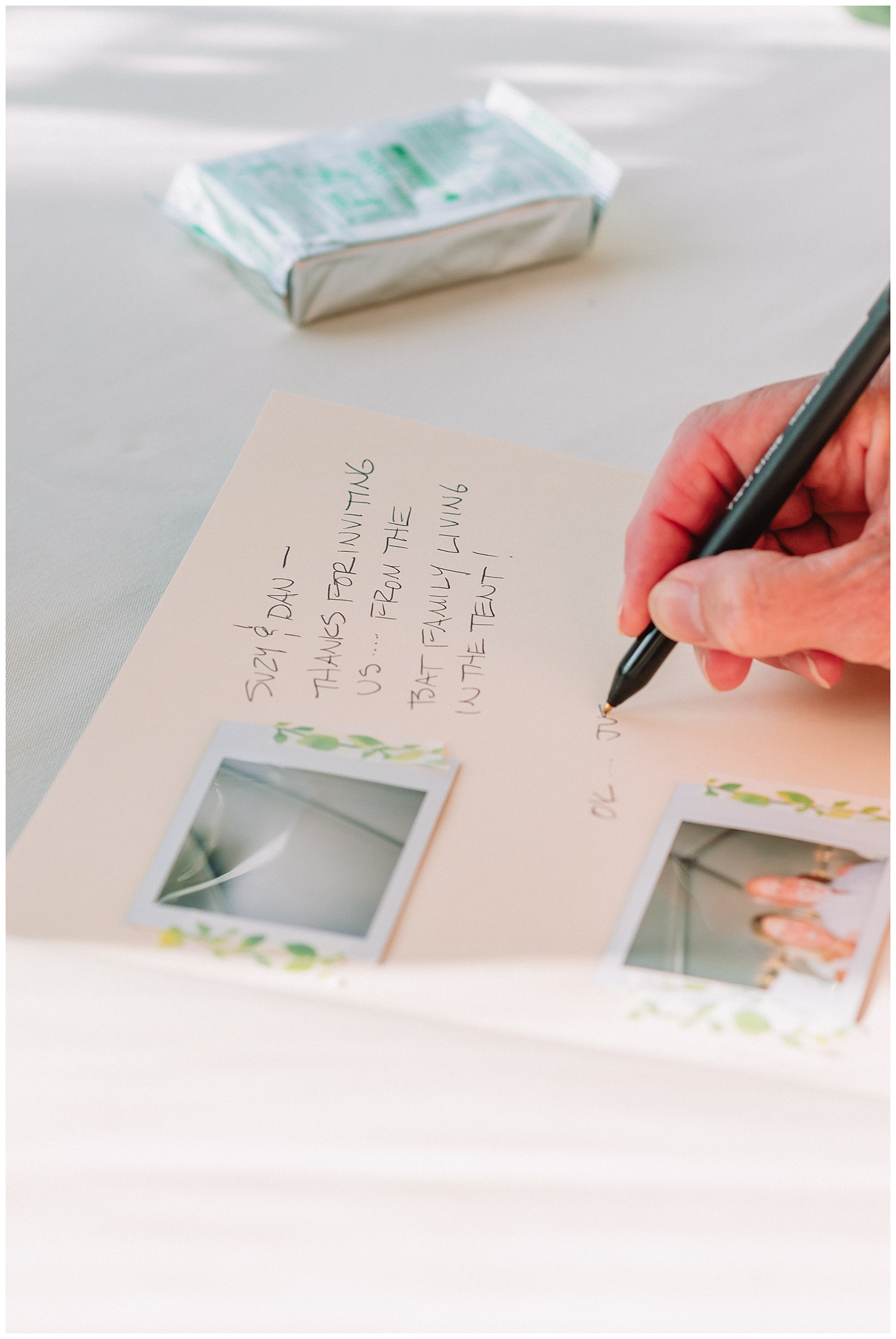 polaroid sign in book being signed by wedding guests