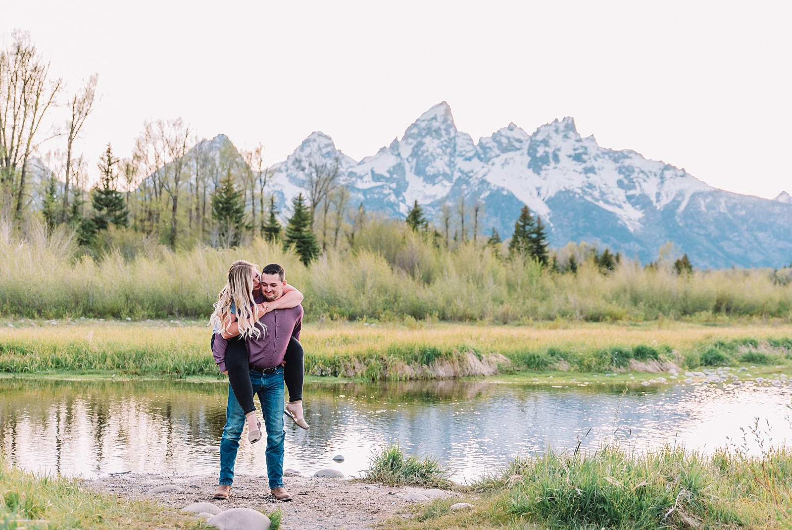 woman on man's back after destination proposal in Jackson Hole