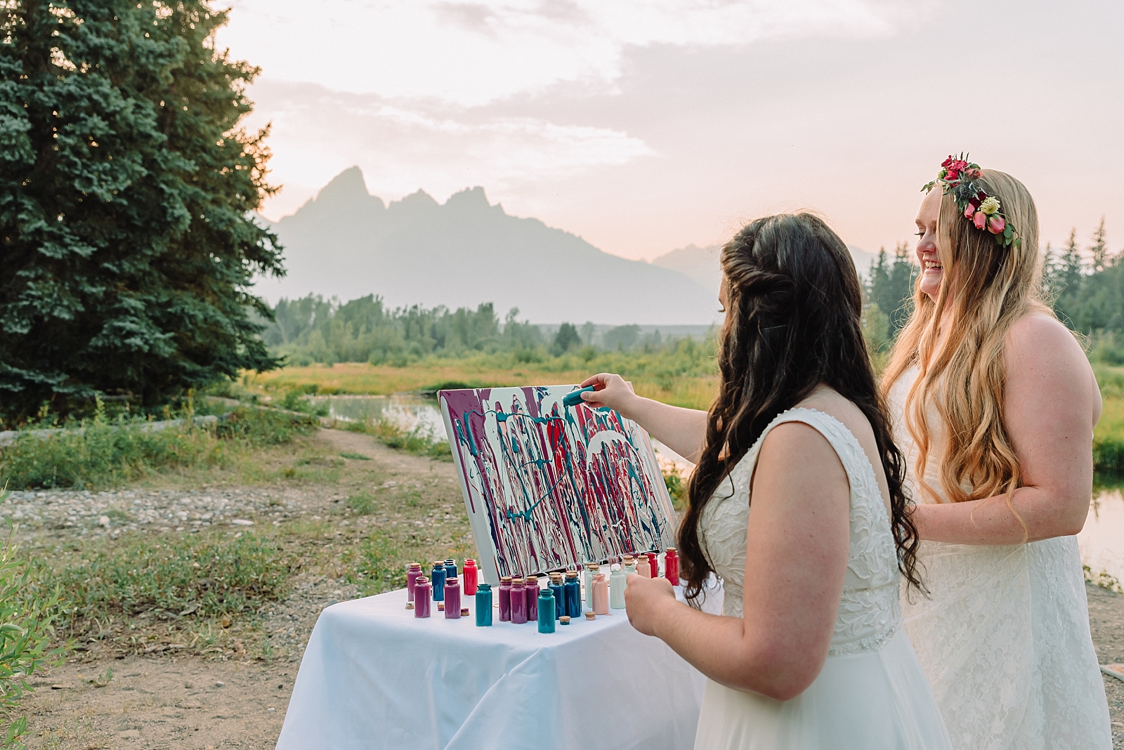 brides add paint to their wedding canvas
