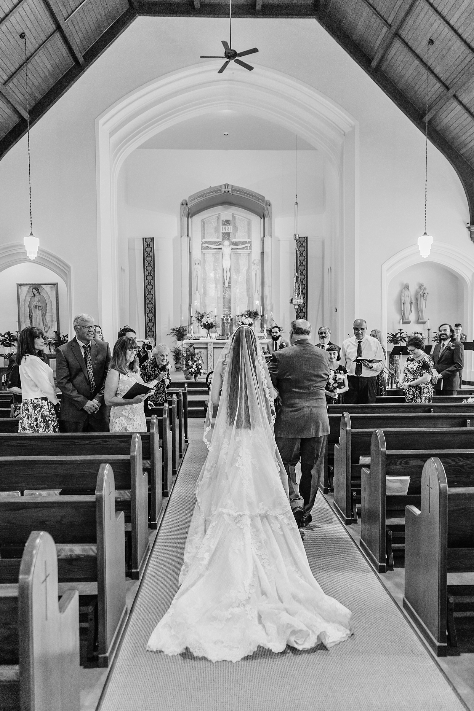Bride walks down aisle at Holy Rosary Chapel