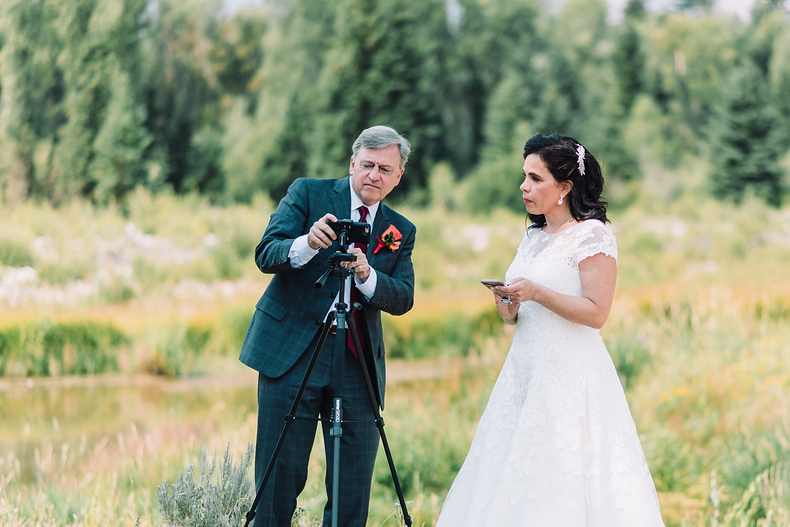 bride and wedding officiant setting up live stream to include family in your elopement