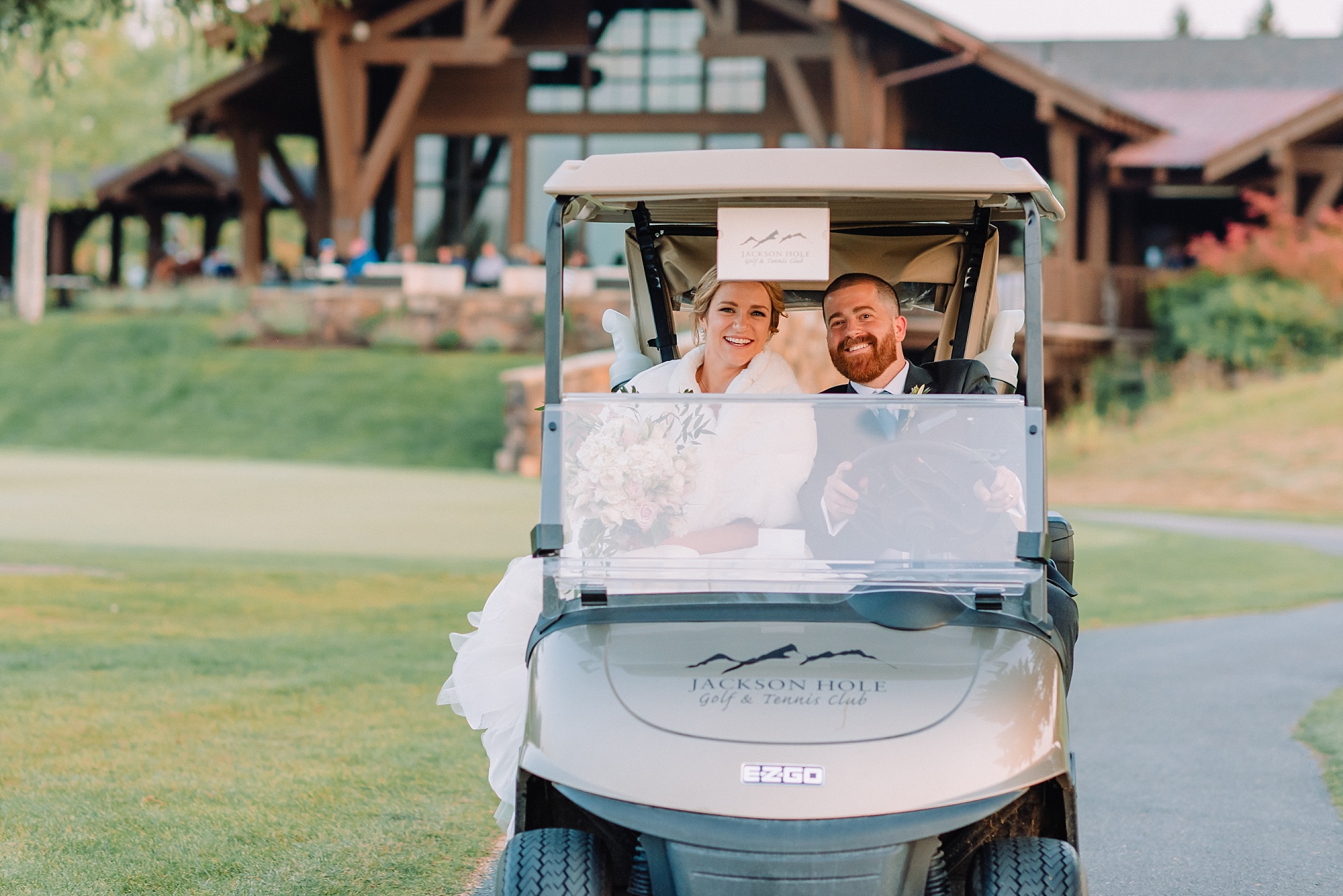 couple rides golf cart on wedding day