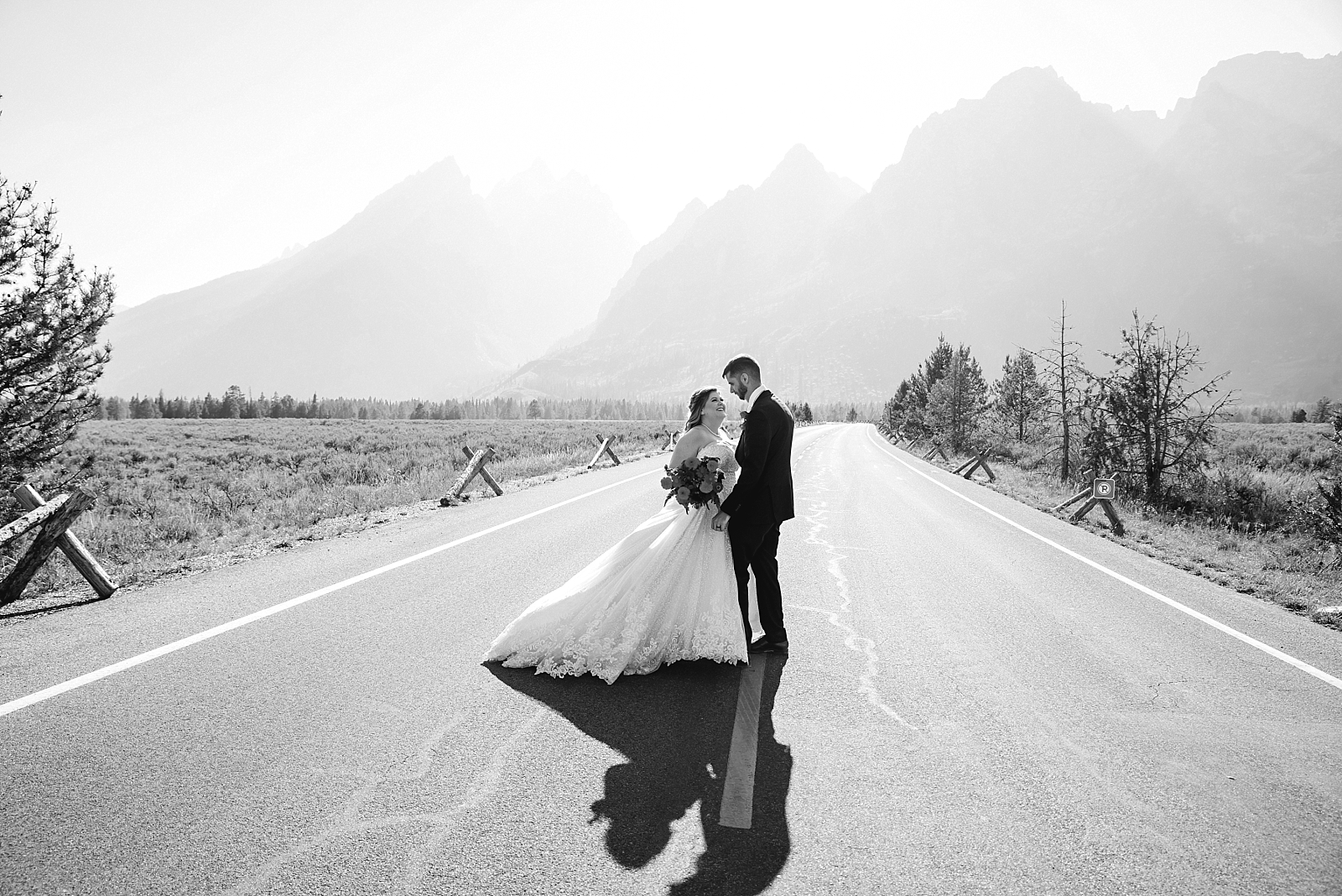 adventurous wedding couple in middle of road