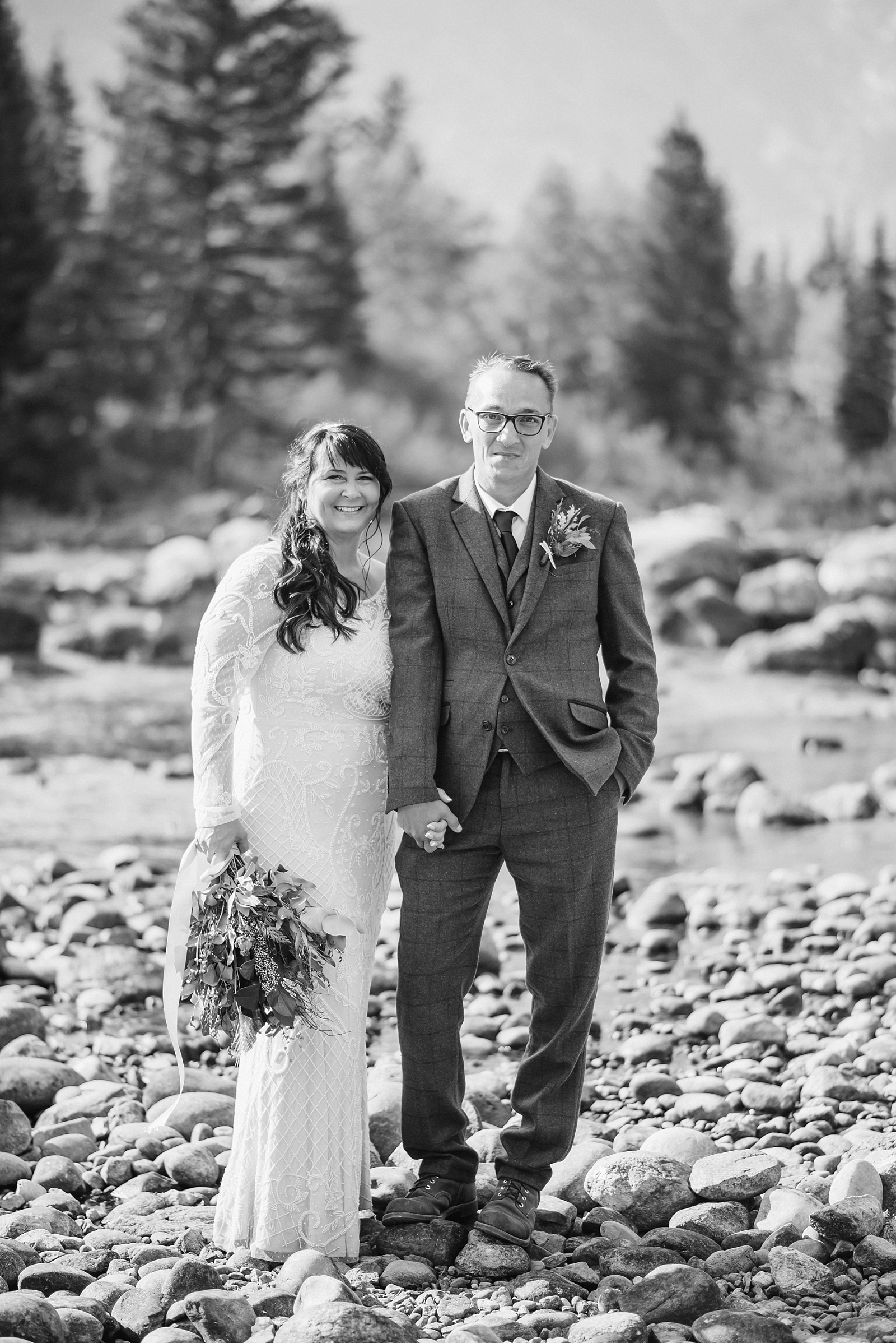 bride and groom at jenny lake river mountains