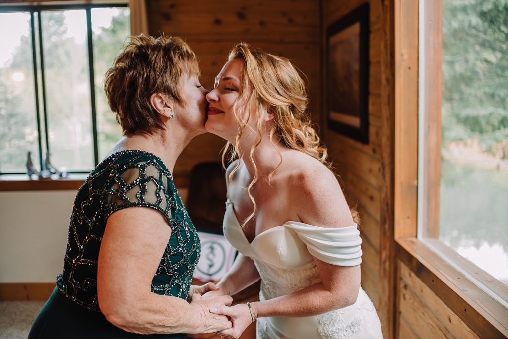 grandma kisses bride's cheek in Wedding Day Getting Ready Photos