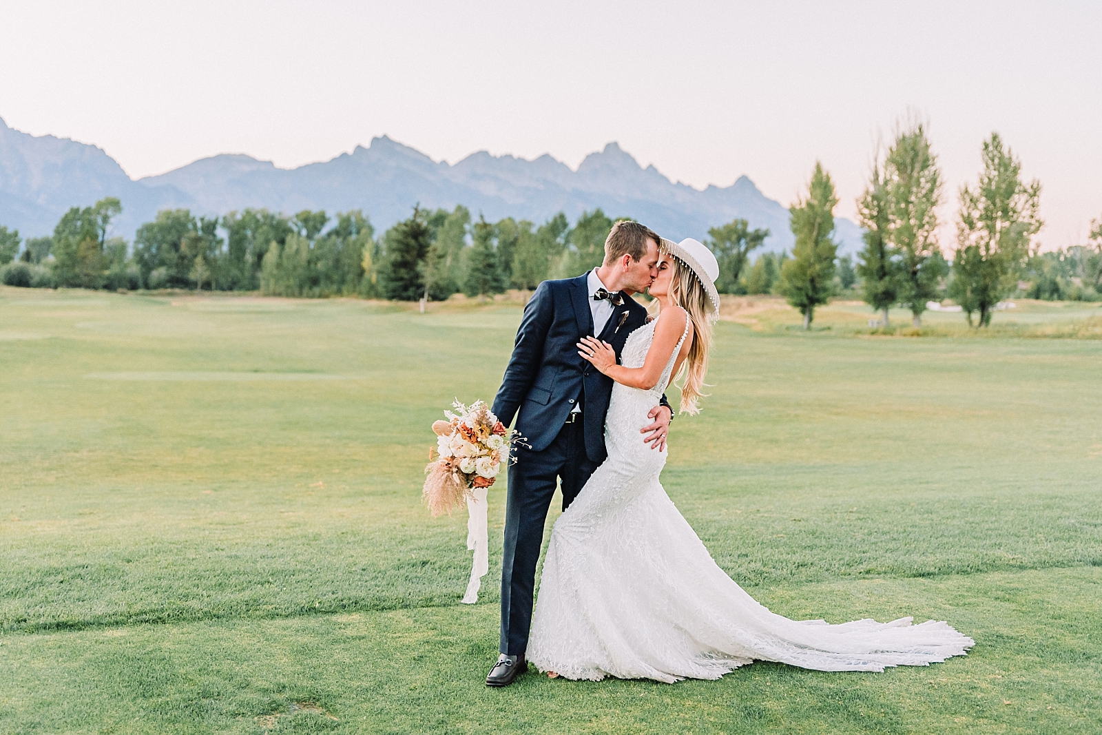 Jackson Hole Golf and Tennis Club Wedding Venue, bride and groom kissing on wedding day