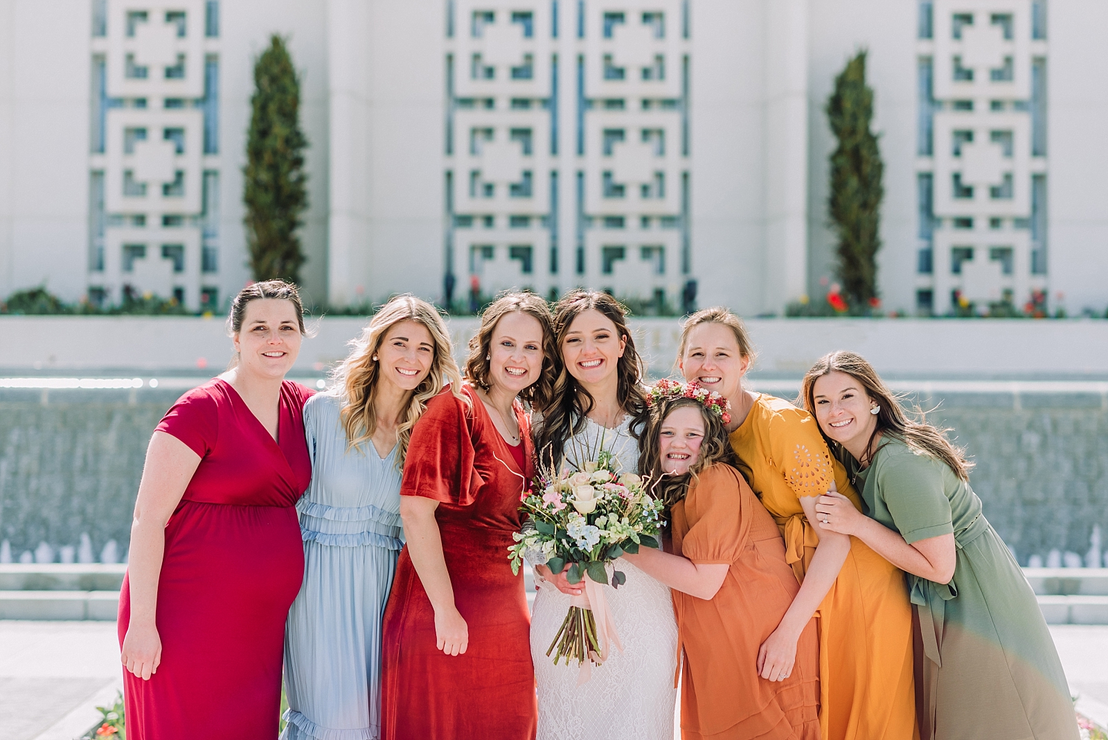 bride with bridesmaids on wedding day