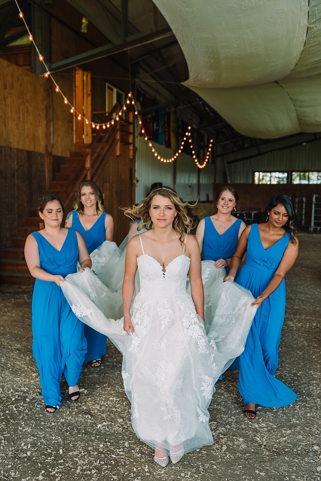 bridesmaids help bride with wedding dress train