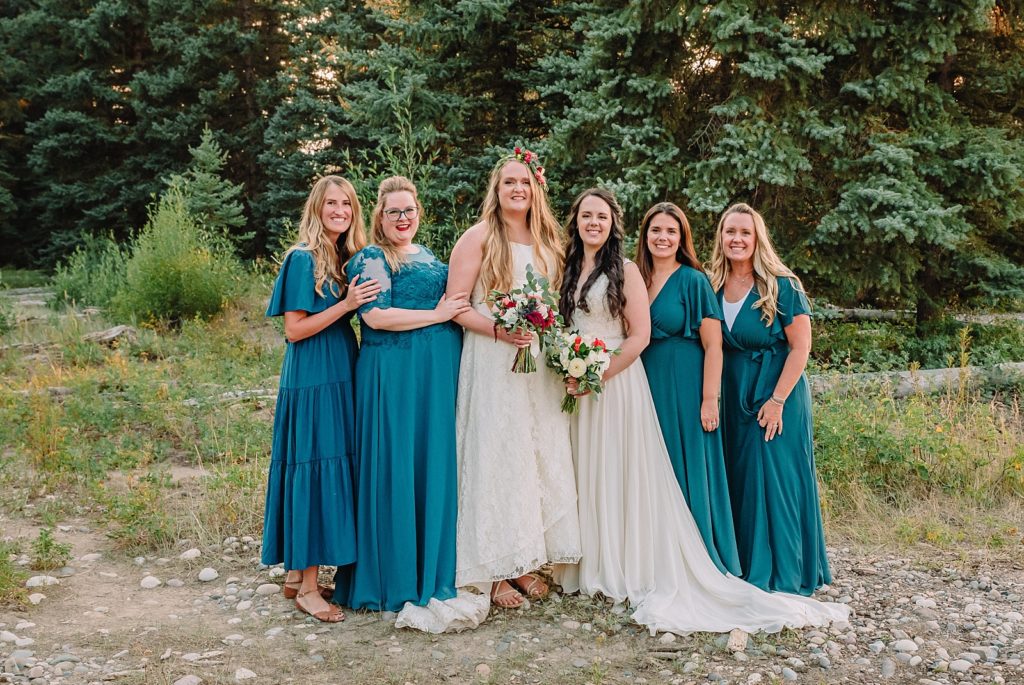 brides and their bridesmaids pose for a wedding portrait