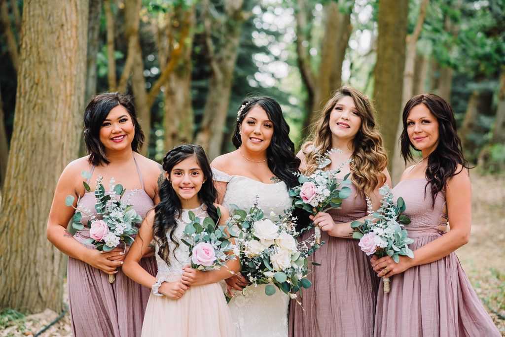 classic bridesmaid pose with flower girl