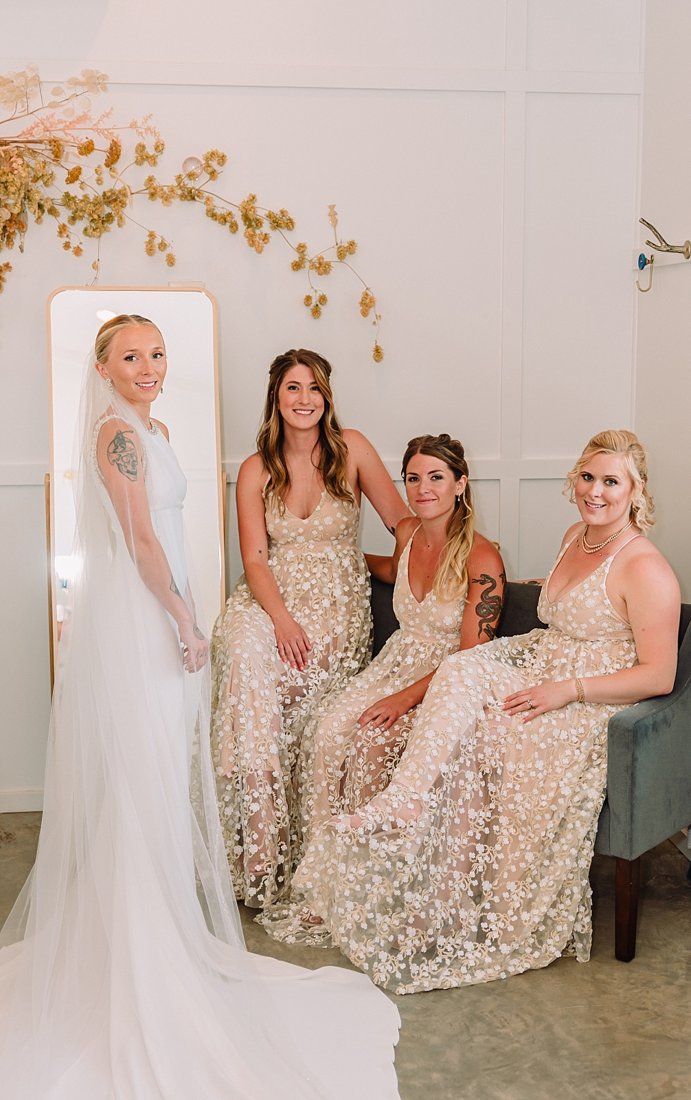 bride and bridesmaids get ready in the bridal room at The Orchard wedding venue, sitting bridesmaid poses