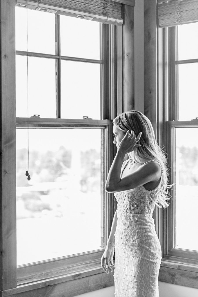 Bride looks out window, Wedding Day getting ready photos at Snow King Resort