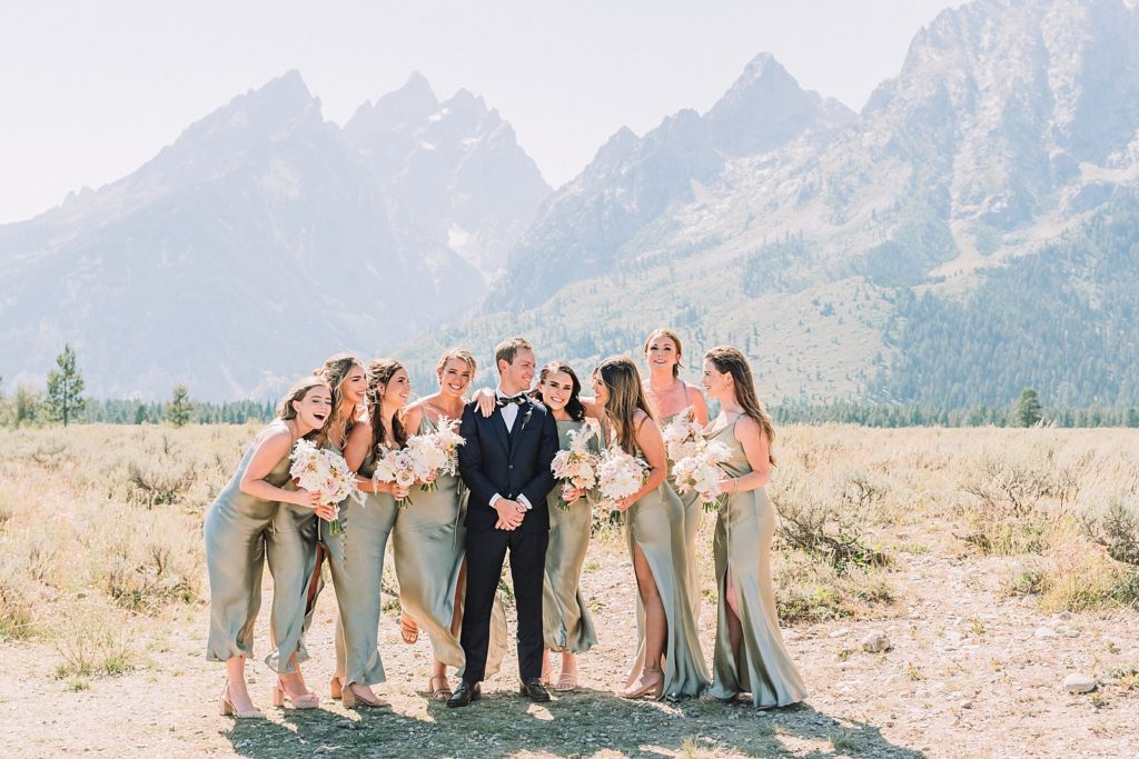 Groom with bridesmaids on wedding day